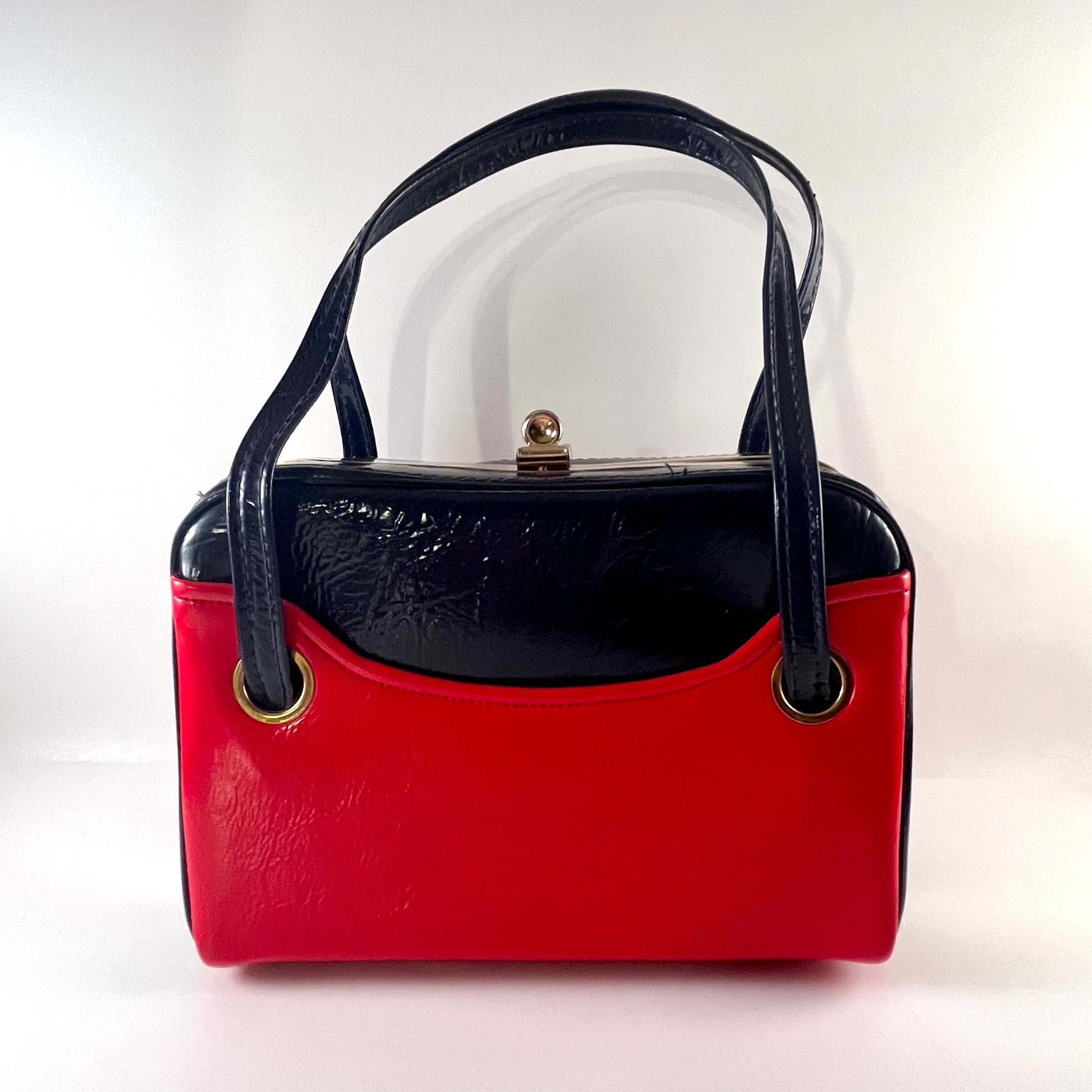 Navy and red handbag sales